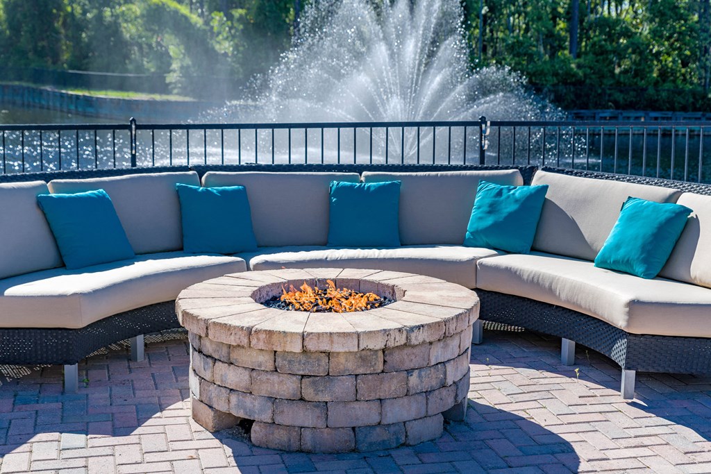 an outdoor seating area with a fire pit and a fountain