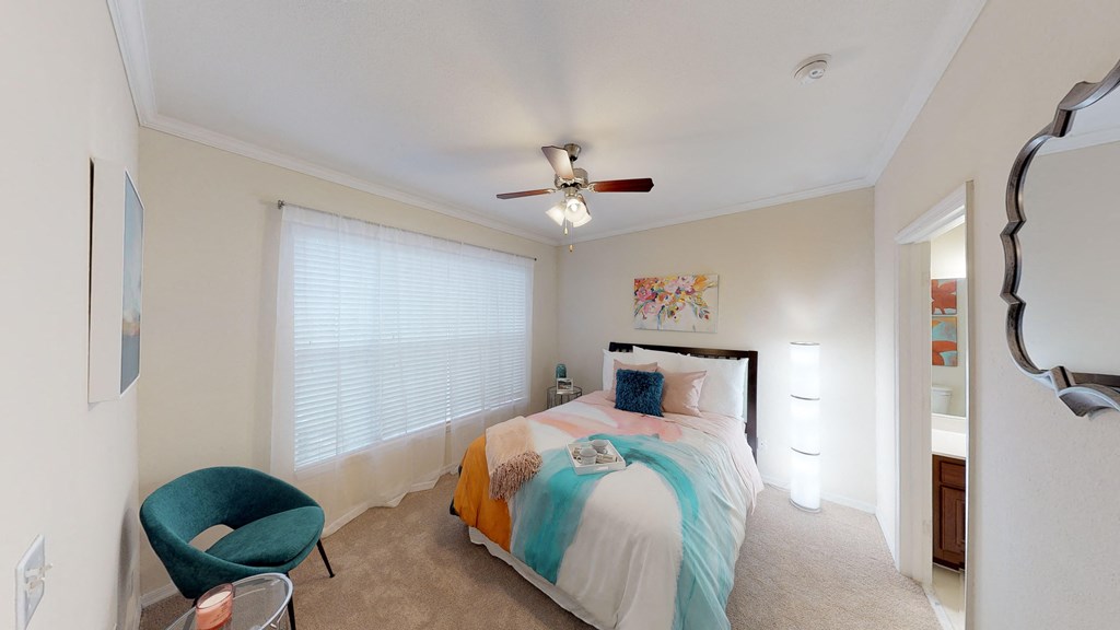 a bedroom with a bed and a ceiling fan