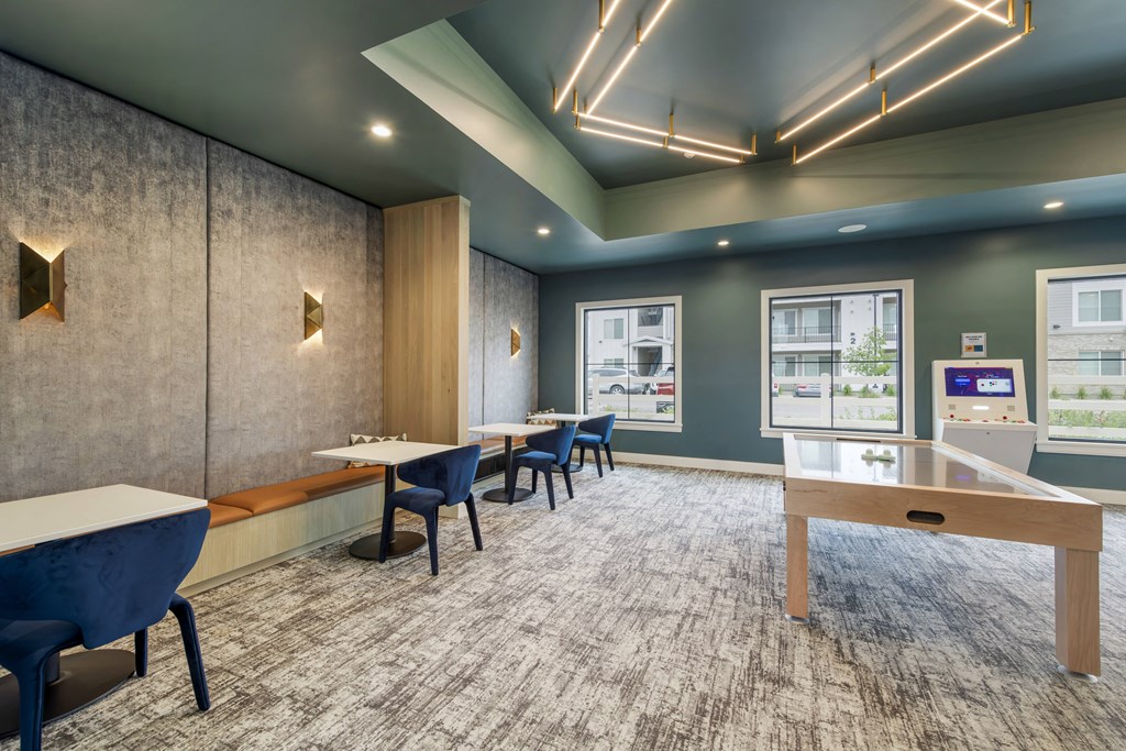 a lounge area with tables and chairs and a display case