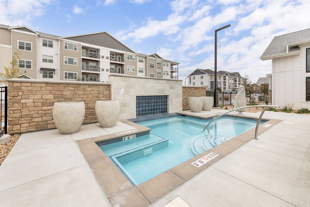 our apartments offer a swimming pool with our apartment building in the background
