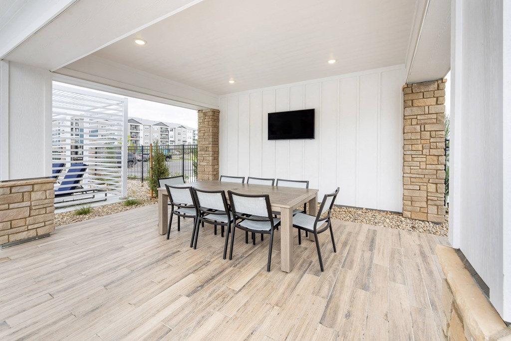 a dining room with a wooden table and chairs