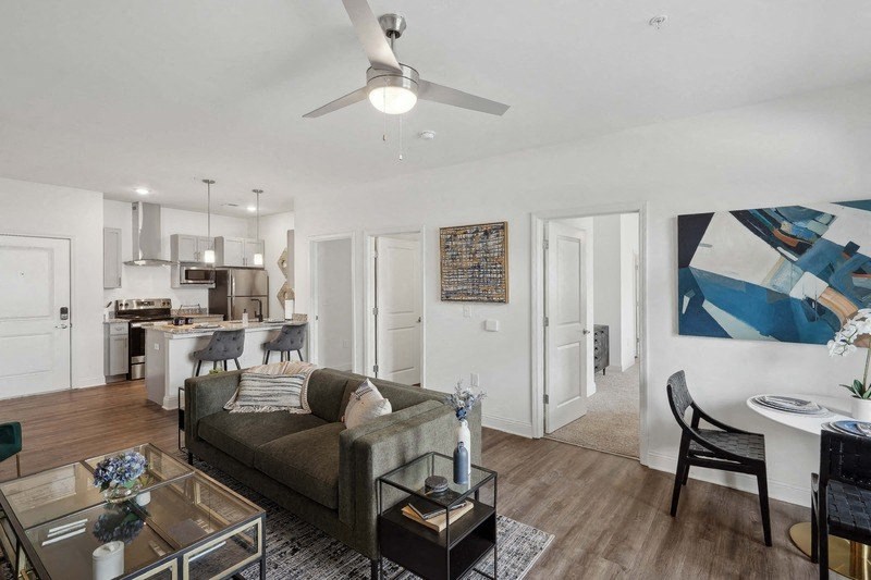 a living room with a couch and a ceiling fan