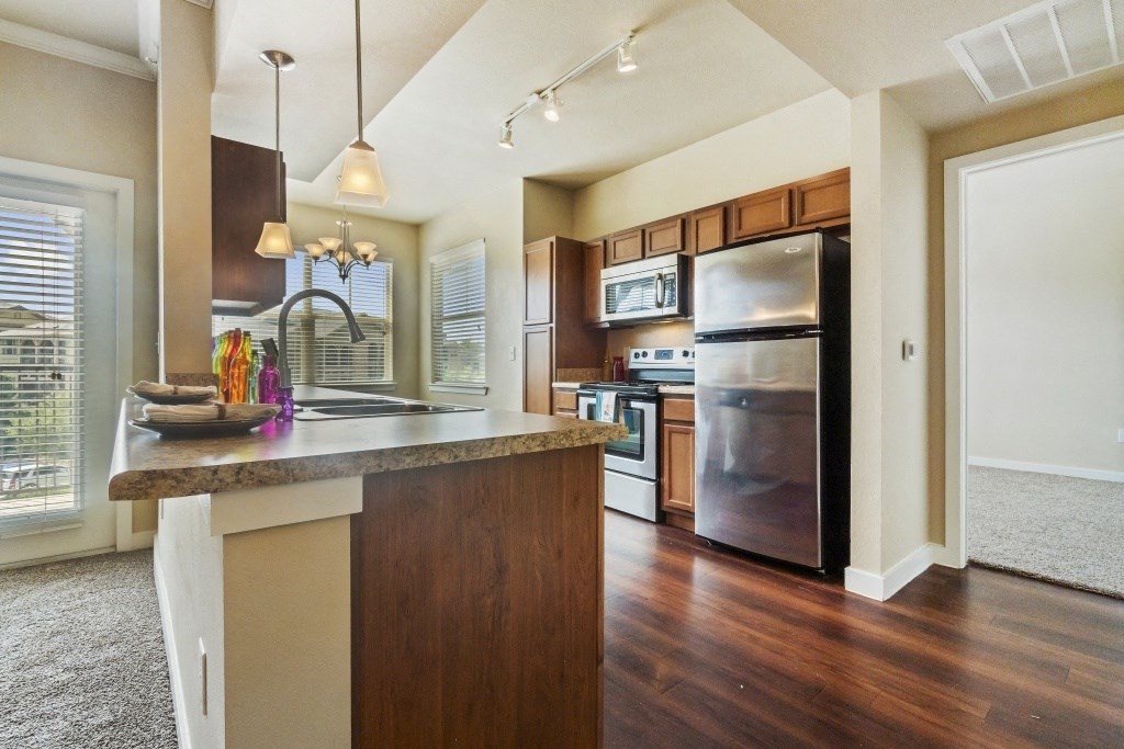 a kitchen with stainless steel appliances and a counter top