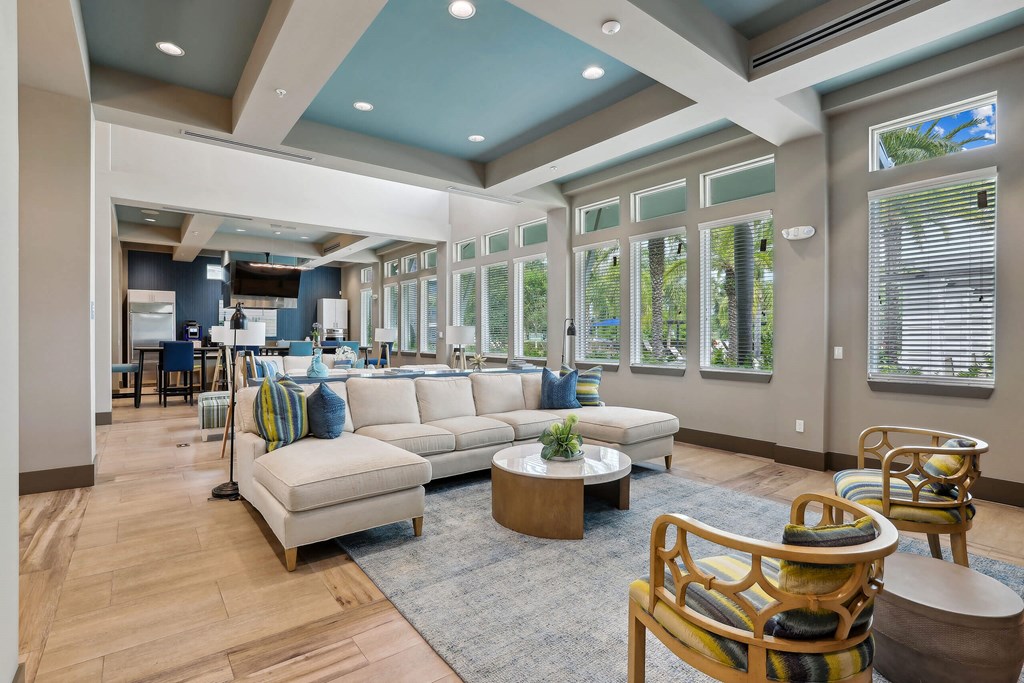 a large living room with couches and chairs