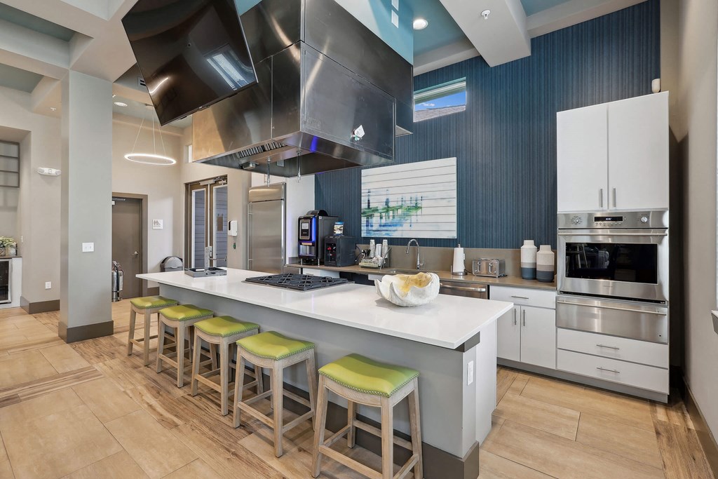 a kitchen with a large island with bar stools