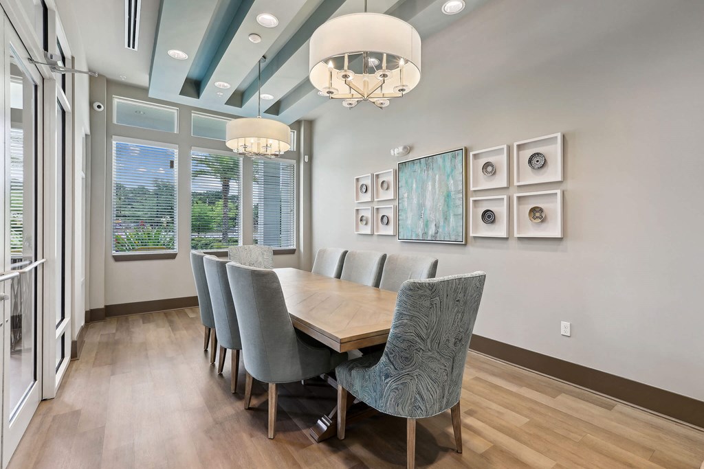 a dining room with a long wooden table and chairs