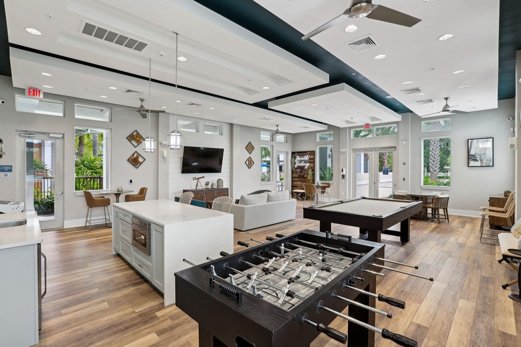 a clubhouse with a foosball table and a pool table