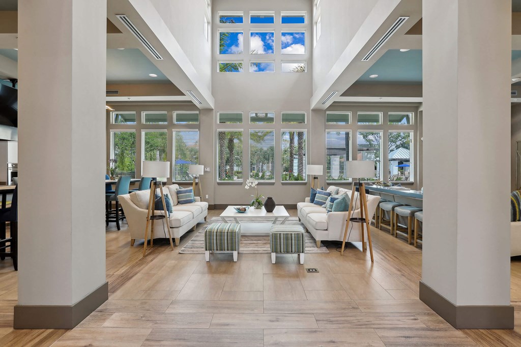 a living room filled with furniture and windows