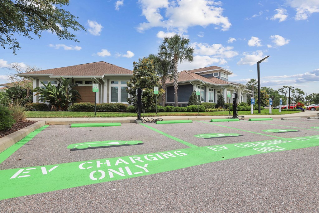 a home with a parking lot with electric charging only