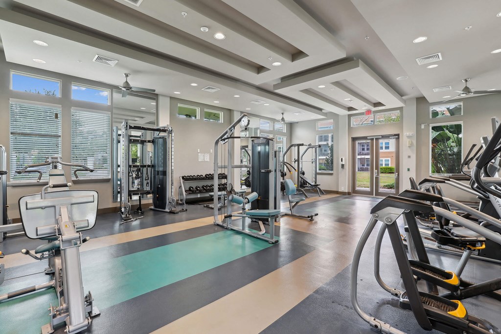 a gym with weights and cardio equipment at the estates at johnsons crossing