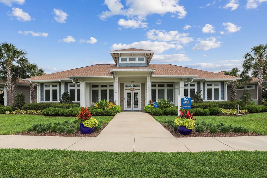 the front of a house with a walkway in front of it