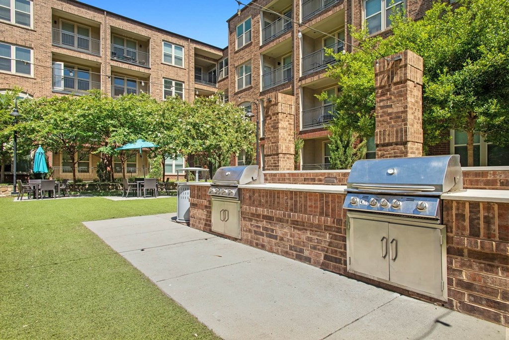 our apartments have a patio with grilling stations and a lawn