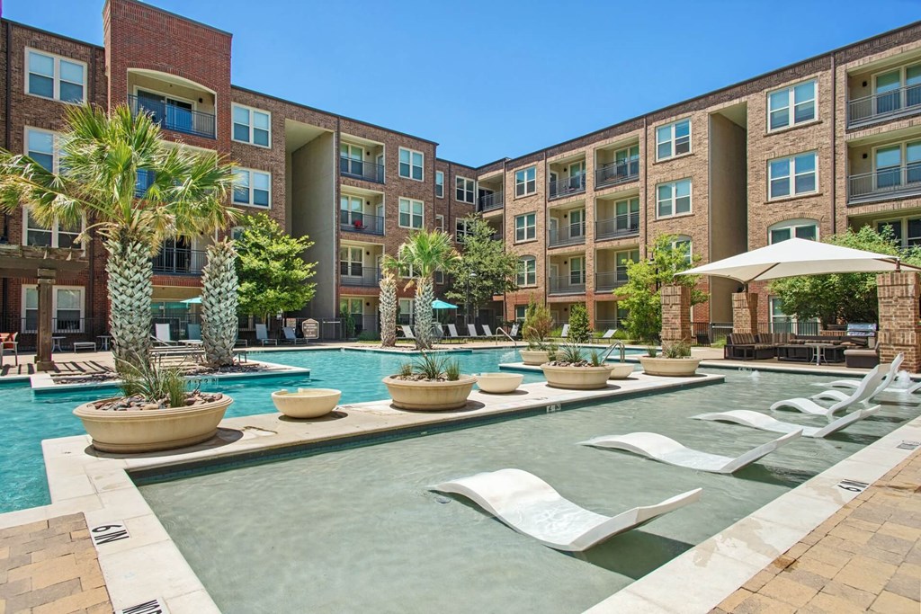 our apartments offer a large swimming pool with lounge chairs and umbrellas