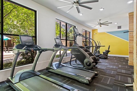A gym with treadmills and exercise bikes.