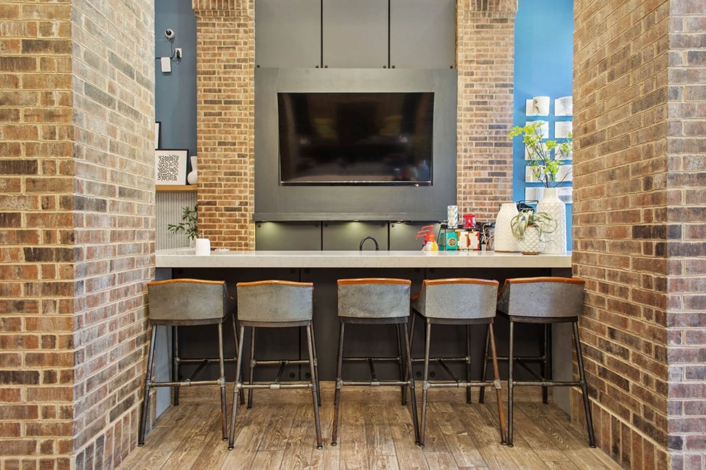 a kitchen with a bar and a television