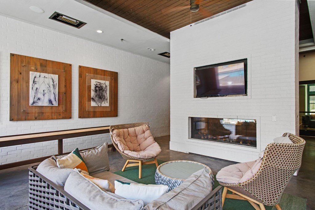 the living room has a white brick wall and a fireplace