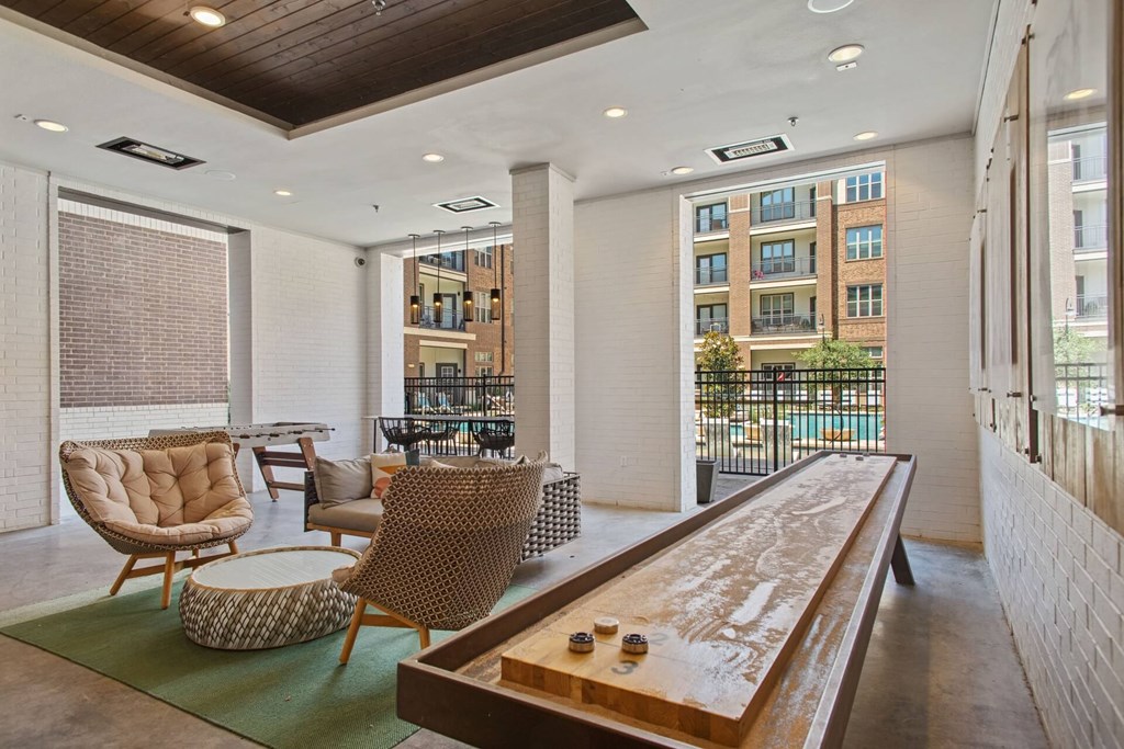 a lobby with a table and chairs and a balcony