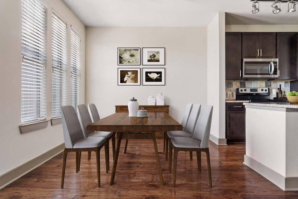 a dining room with a wooden table and chairs