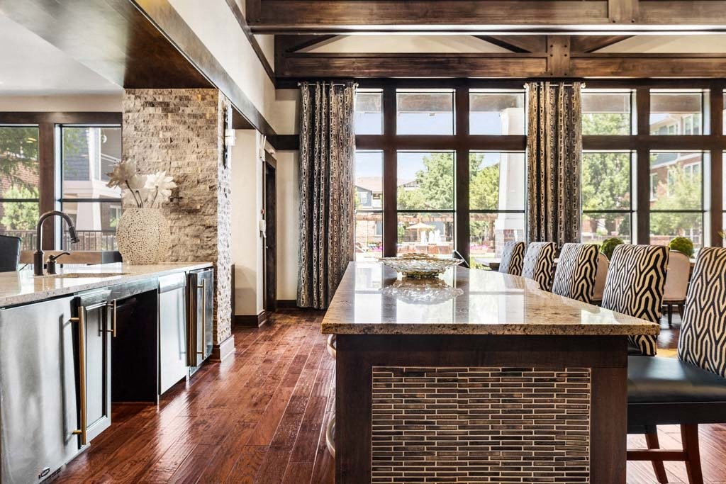 a kitchen with a marble counter top and a large window