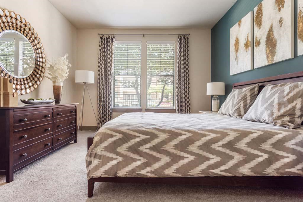 a bedroom with a bed and a dresser