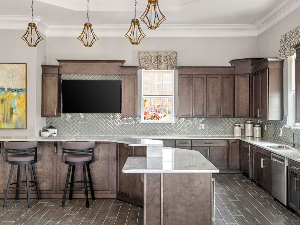 A kitchen with a bar area and a television.