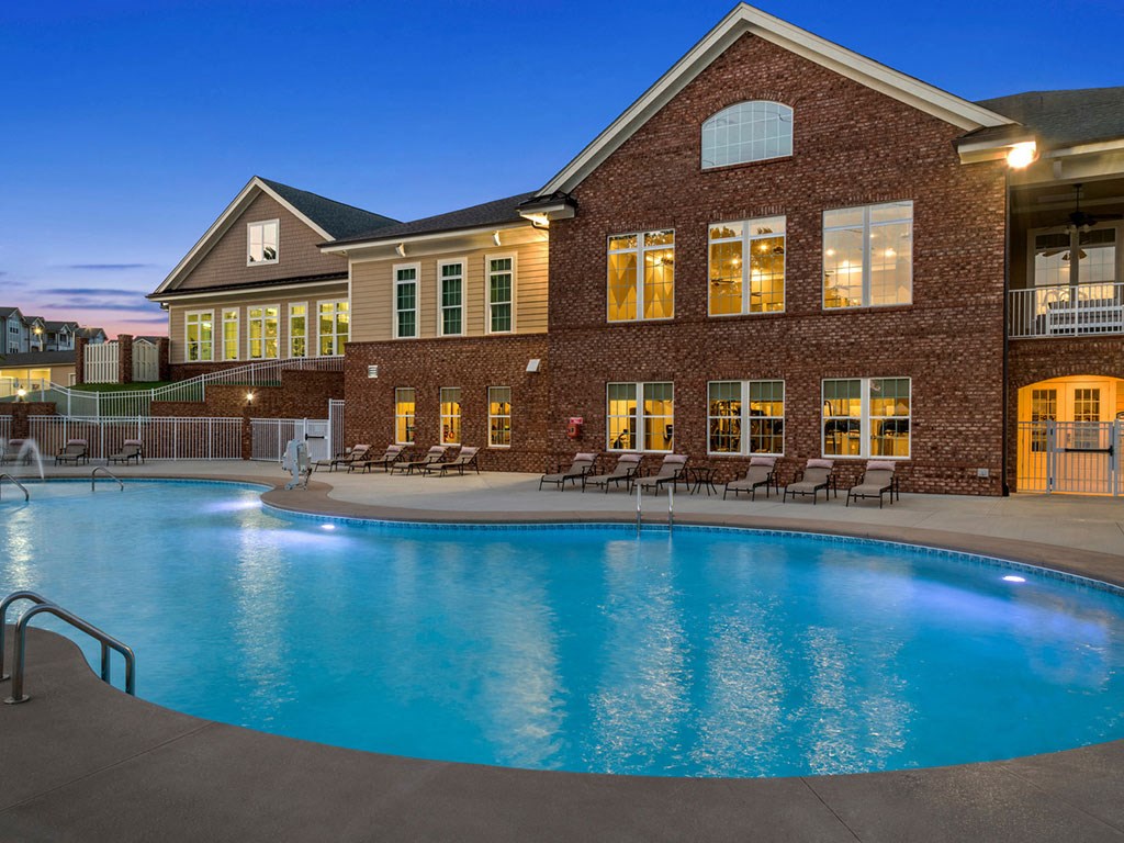 A large house with a pool in front.