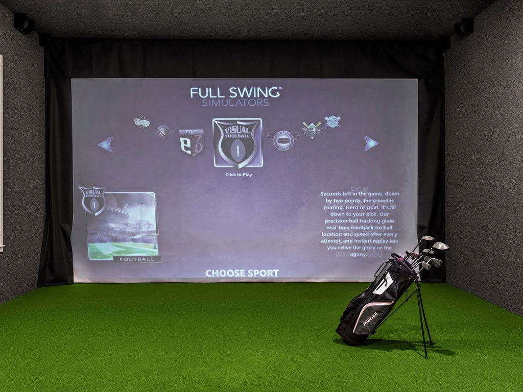 A golf simulator room with a screen showing the game options.