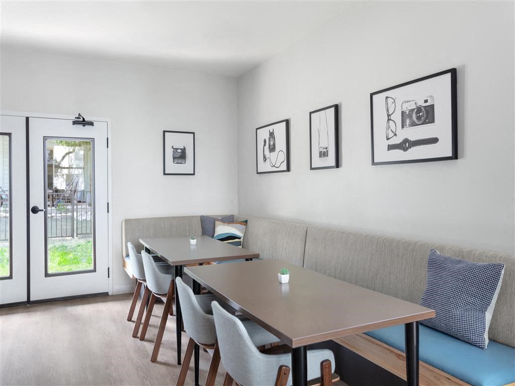 a dining room with tables and chairs and pictures on the wall