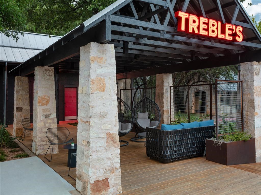 the outside of a trebles restaurant with a wooden deck