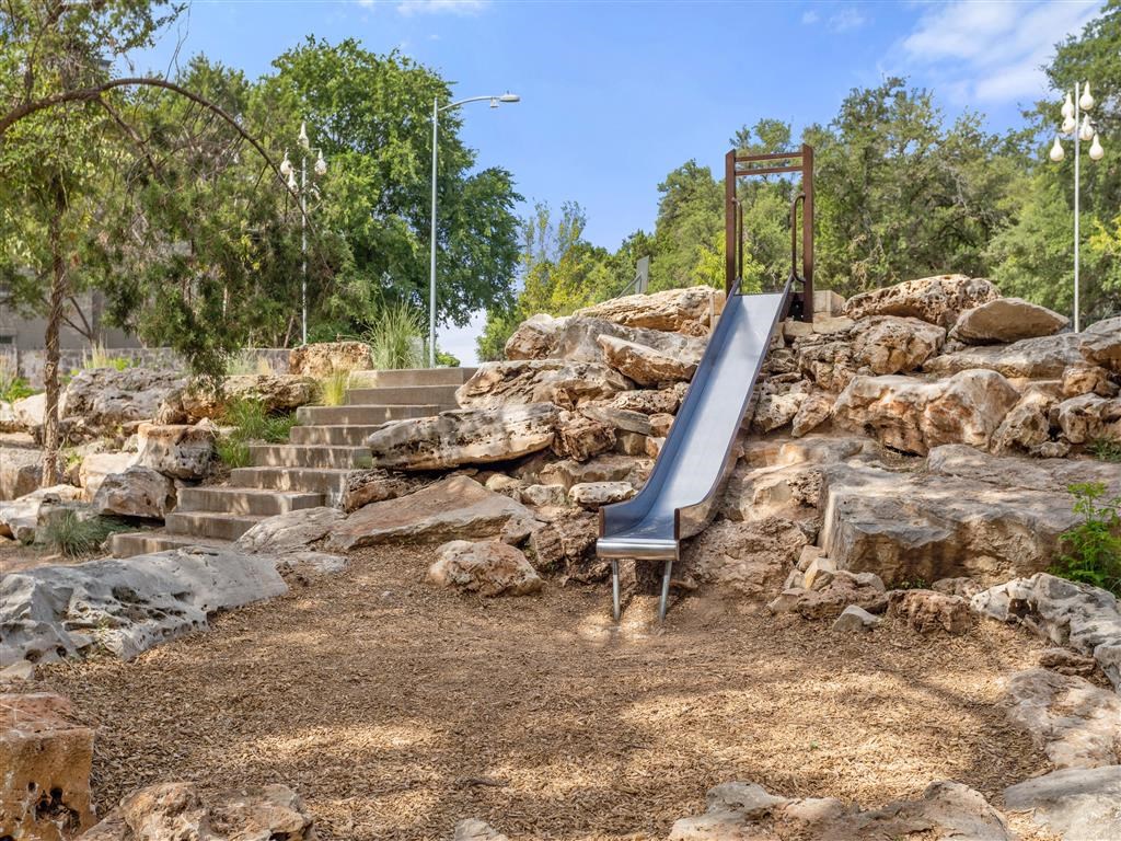 a slide on a rock hill in a park