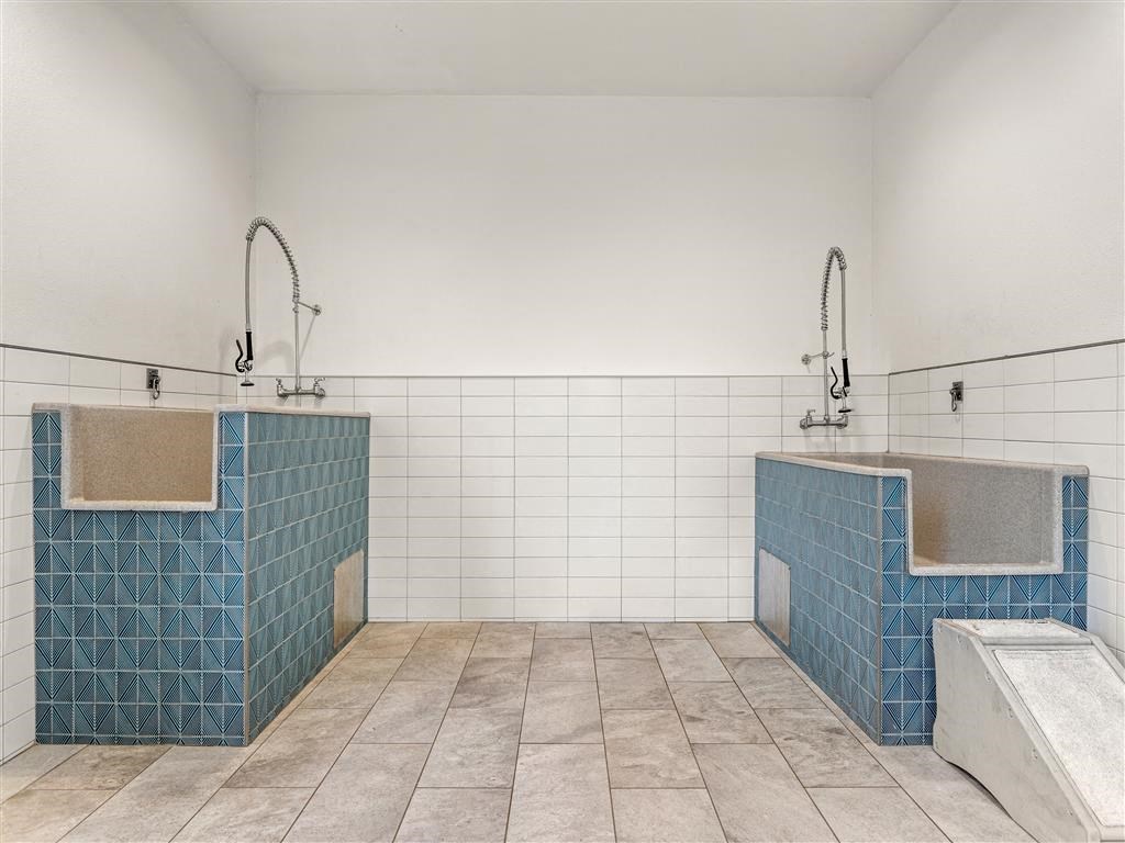 a large bathroom with two sinks and a tub