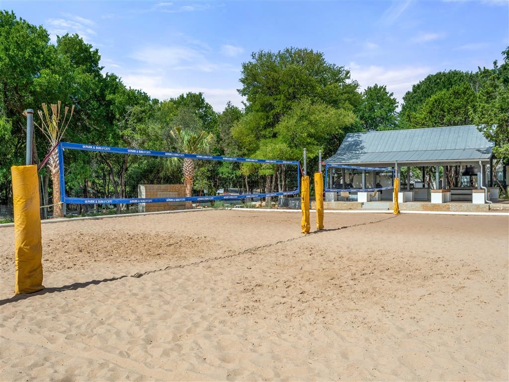 a volleyball court with a pavilion in the middle of the sand