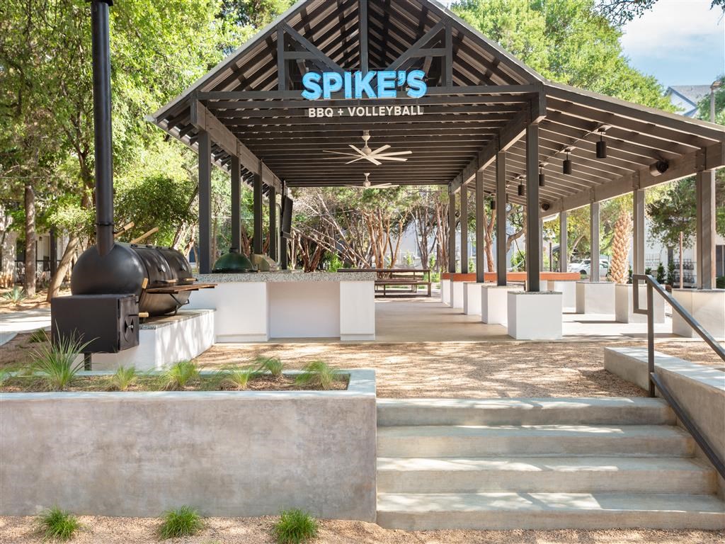 a pavilion with a grill and a sign that reads spikes