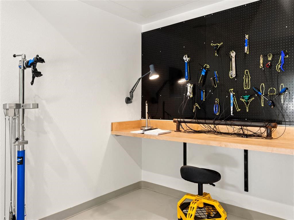 a work space with a desk and a large display of tools