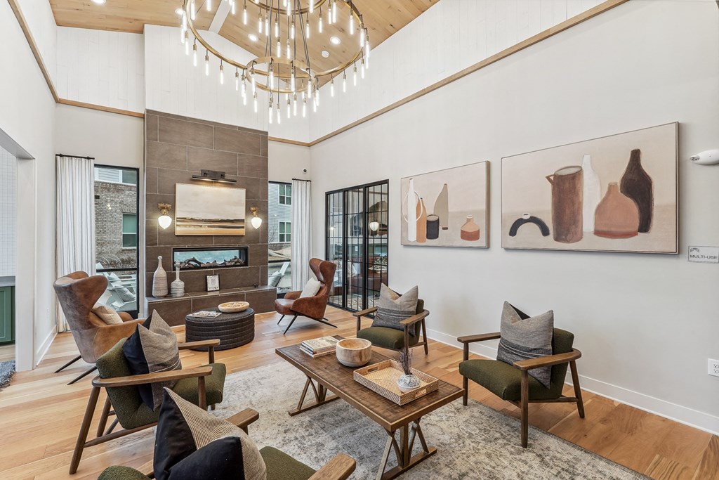 a living room with a fireplace and a chandelier