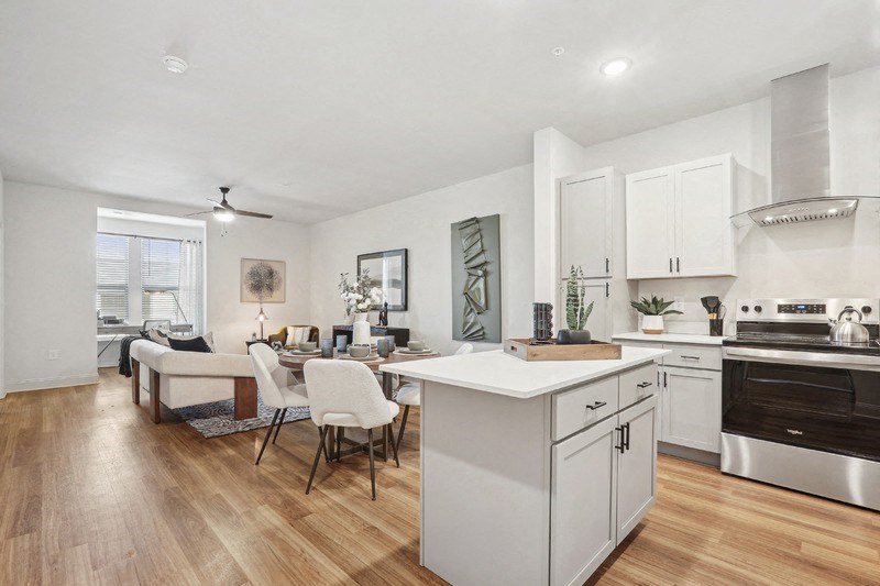 A modern kitchen with a dining table and chairs.