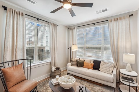 a living room with a couch and a ceiling fan