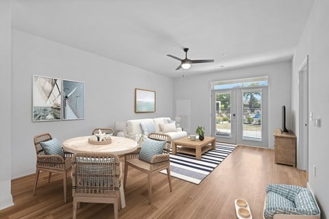 A dining room with a round table and chairs.