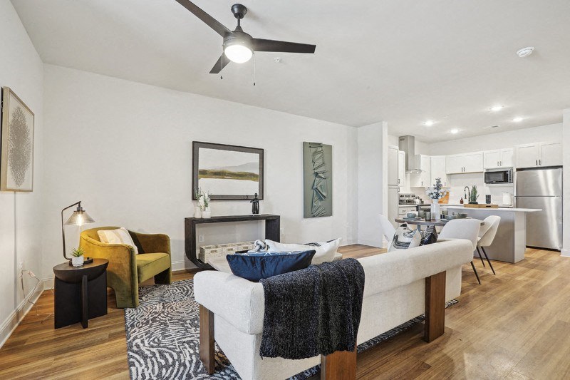 A modern living room with a white sofa and a zebra print rug.