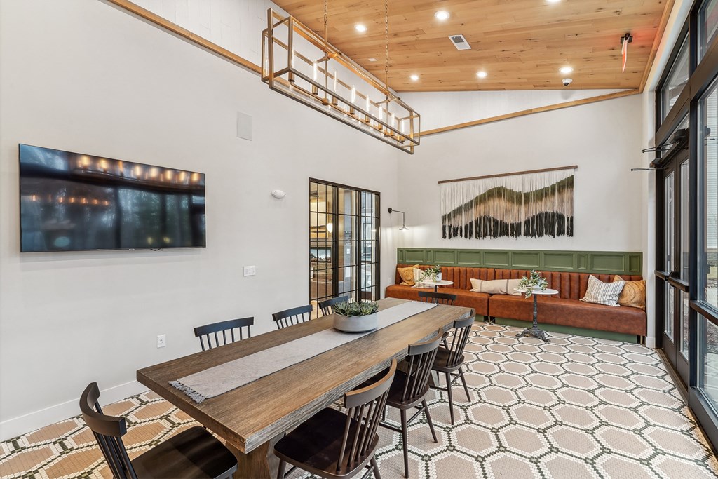 a dining area with a wooden table and chairs and a living room with a couch