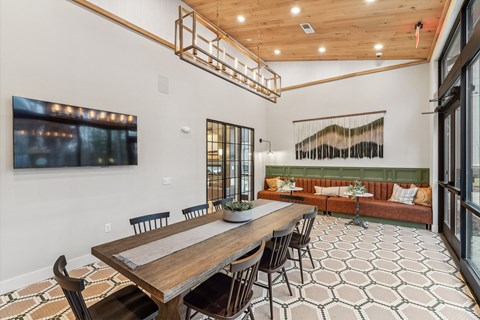 a dining area with a wooden table and chairs and a living room with a couch