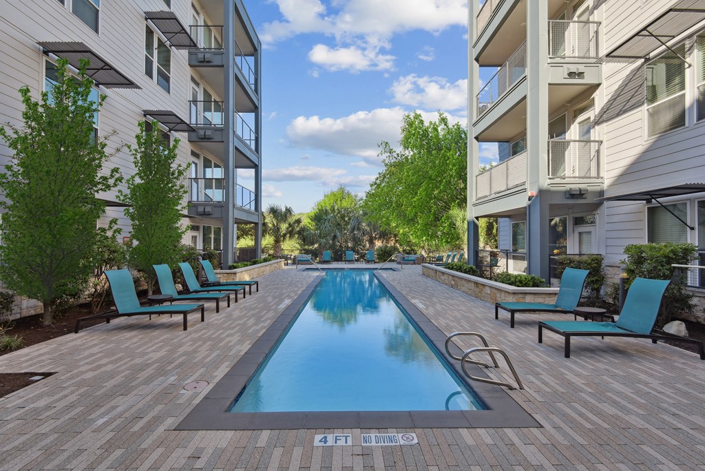 a swimming pool in the middle of two apartment buildings