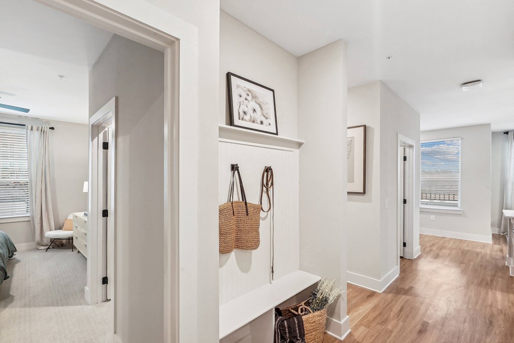 a hallway with a door to a bedroom and a door into a living room