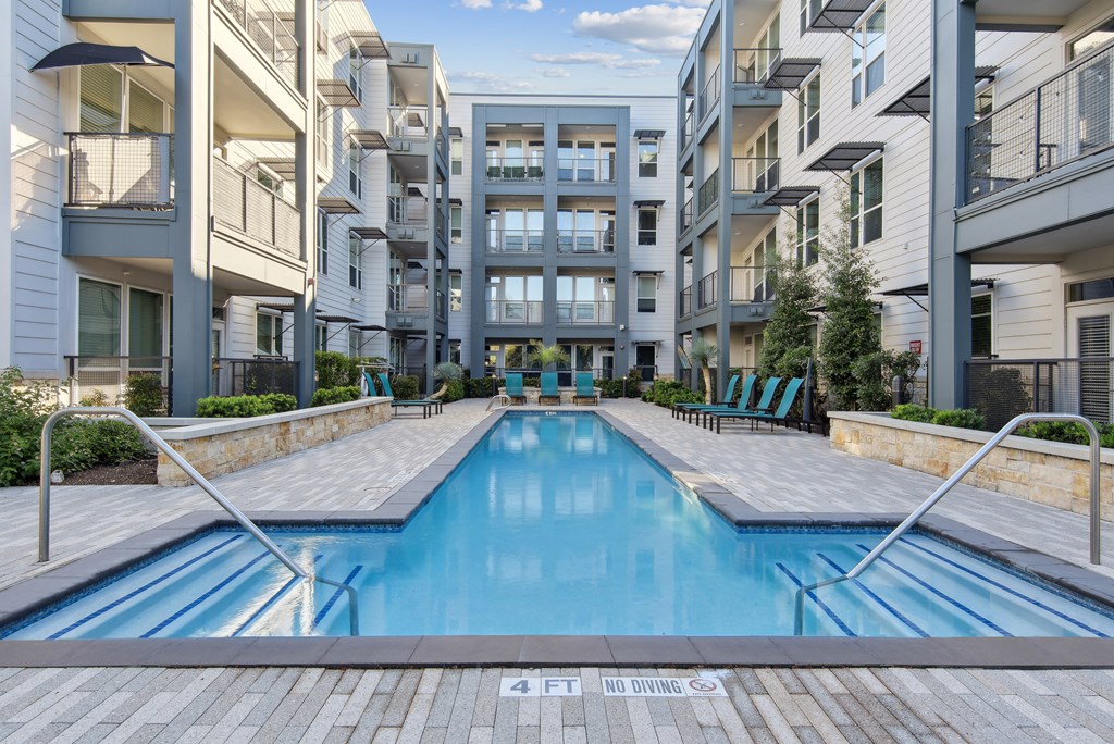 a swimming pool in the middle of an apartment building