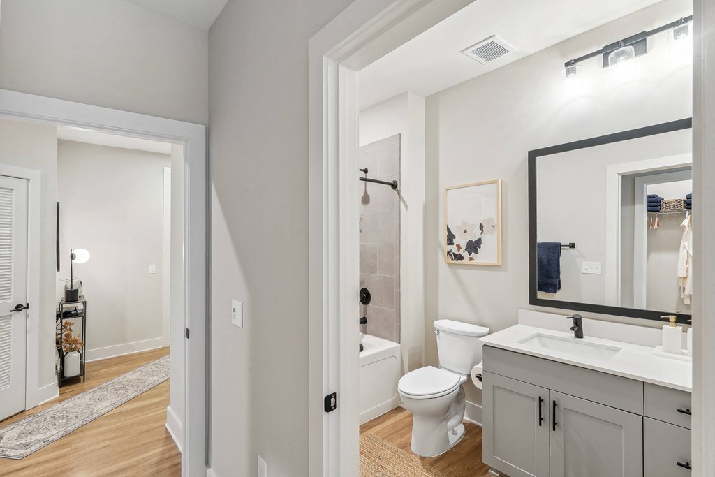 a bathroom with a toilet and a sink and a mirror