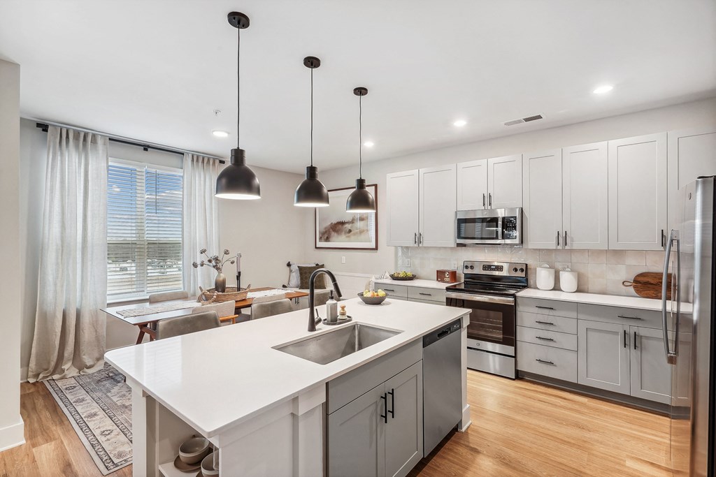 a kitchen with white cabinets and a white counter top
