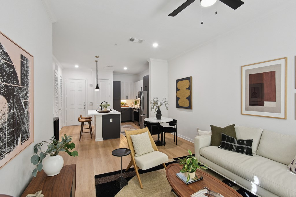 a living room with a white couch and a table with chairs
