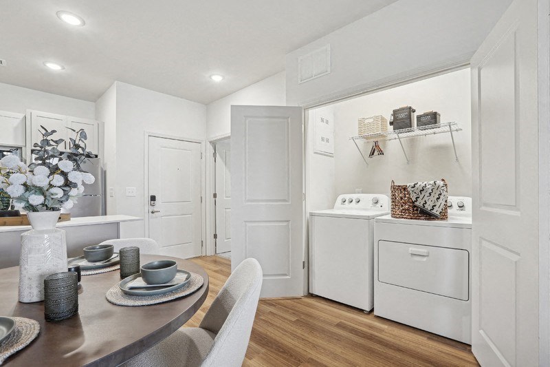 A modern kitchen with a dining table set for two.