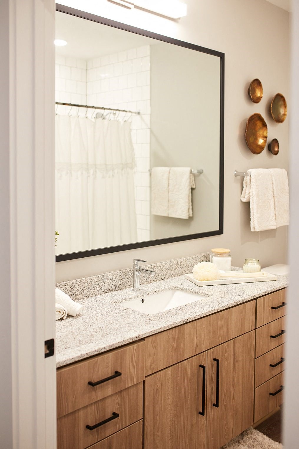 bathroom with large framed mirror