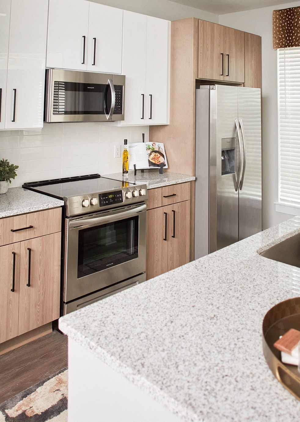 kitchen with two-tone wood and white cabinetry